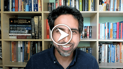 Sal Kahn in front of a bookshelf full of books